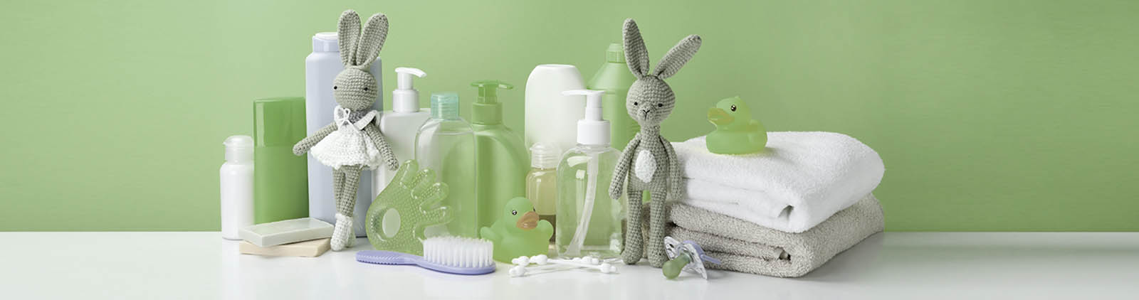 Different baby hygiene accessories against yellow background